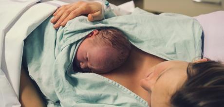 New born baby on mother's chest in hospital