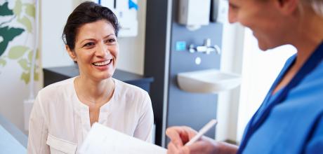 Woman talking to female nurse at hospital 