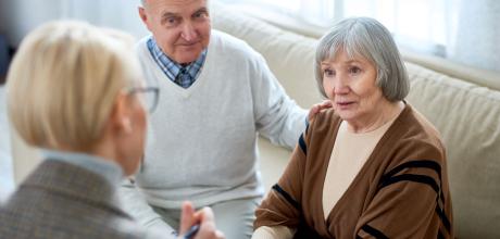 A couple sitting down with a clinician