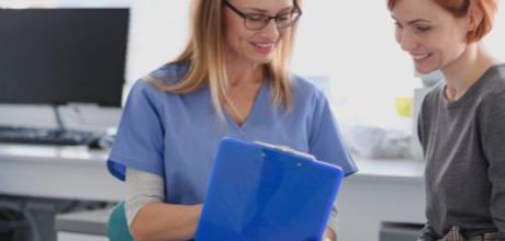 Doctor with clipboard and patient