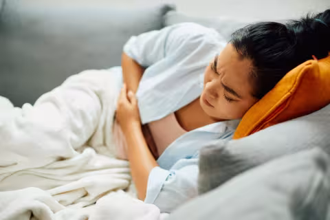 Woman holding stomach in pain