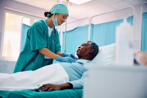 Man in hospital bed receiving treatment