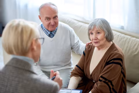 A couple sitting down with a clinician