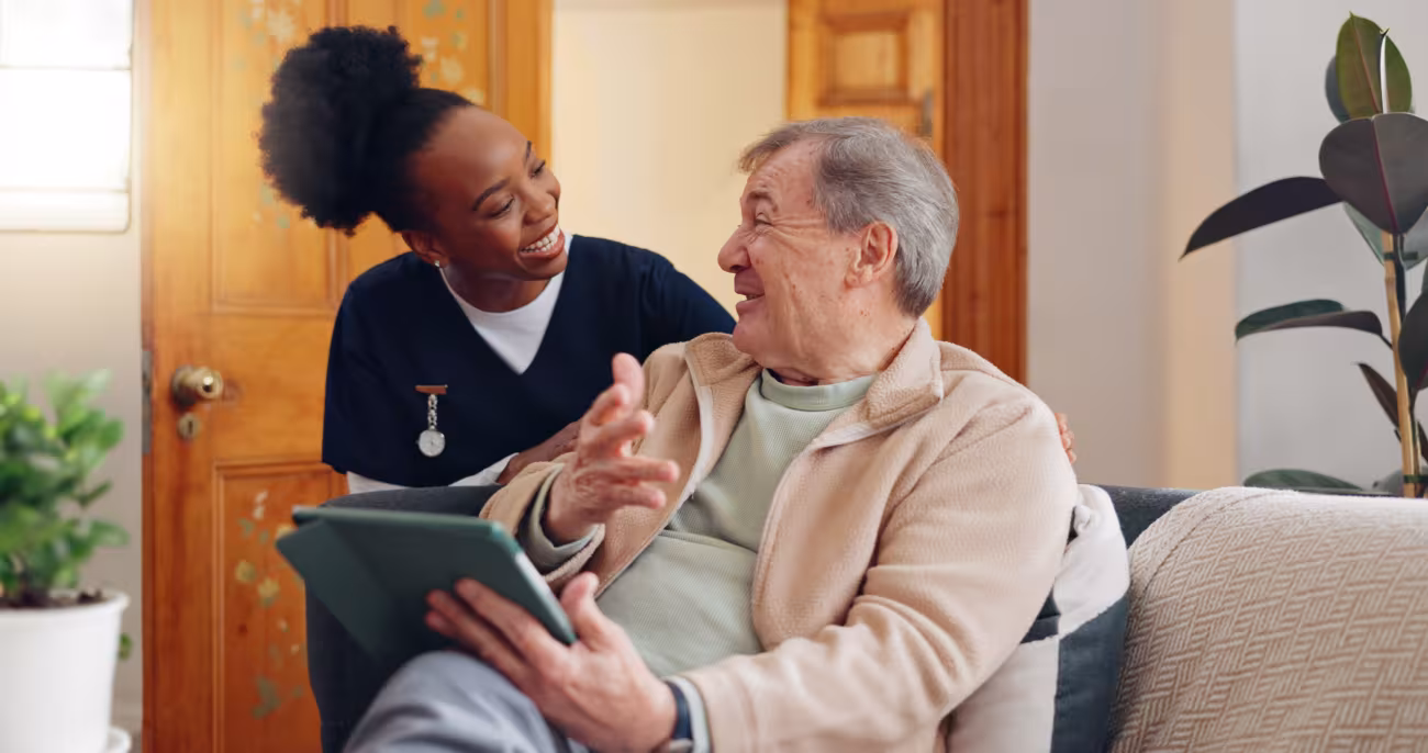 Patient holding an digital device talking to a nurse