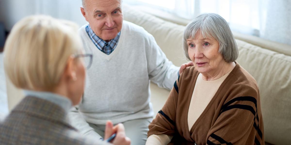 A couple sitting down with a clinician