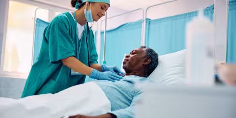 Man in hospital bed receiving treatment
