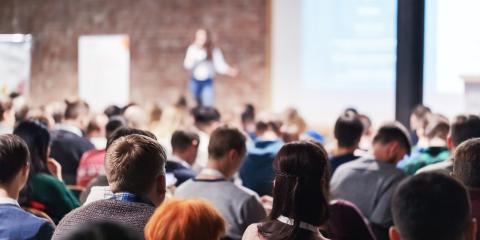 People at a conference listening to a keynote