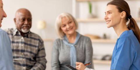 Female clinician talking with a group of people in a white room